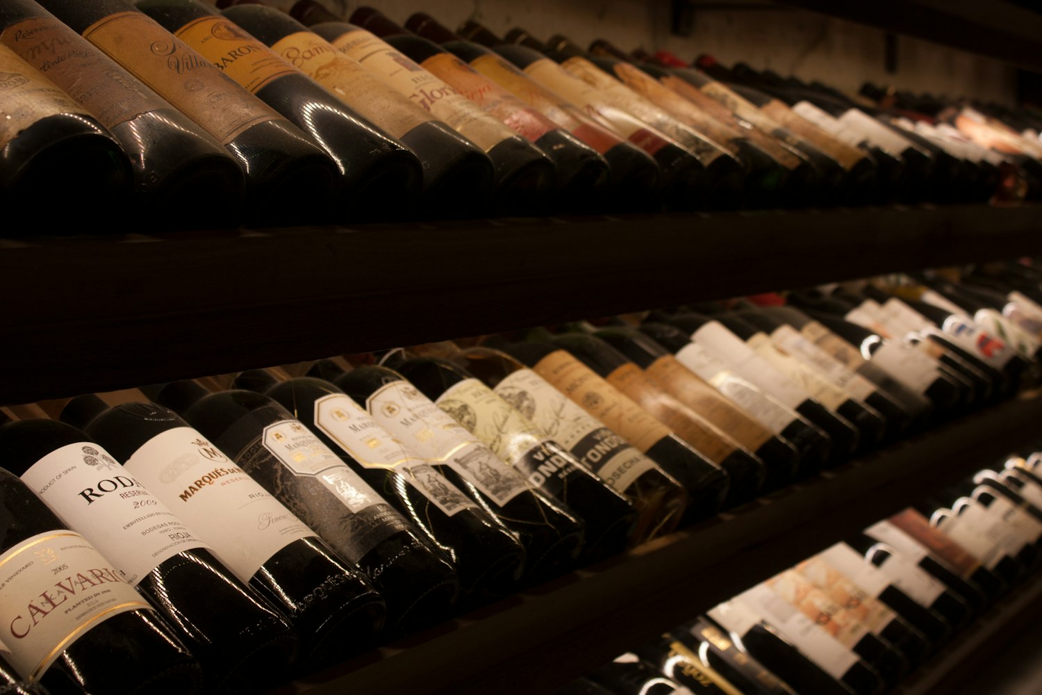 Wine bottles resting in the temperature-controlled cellar racks
